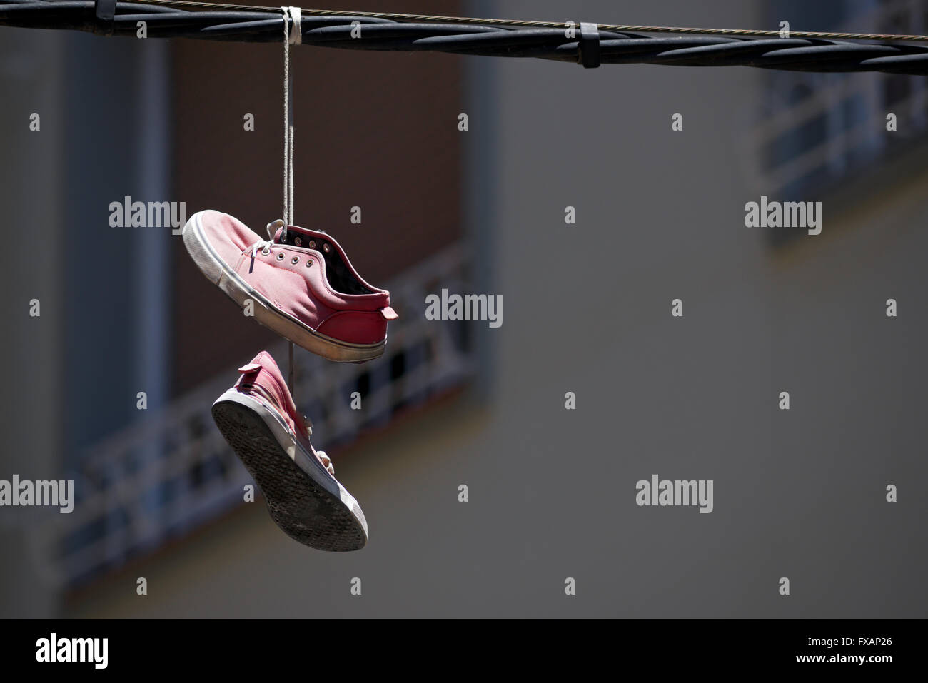 Old sneakers hanging from a cable Stock Photo Alamy