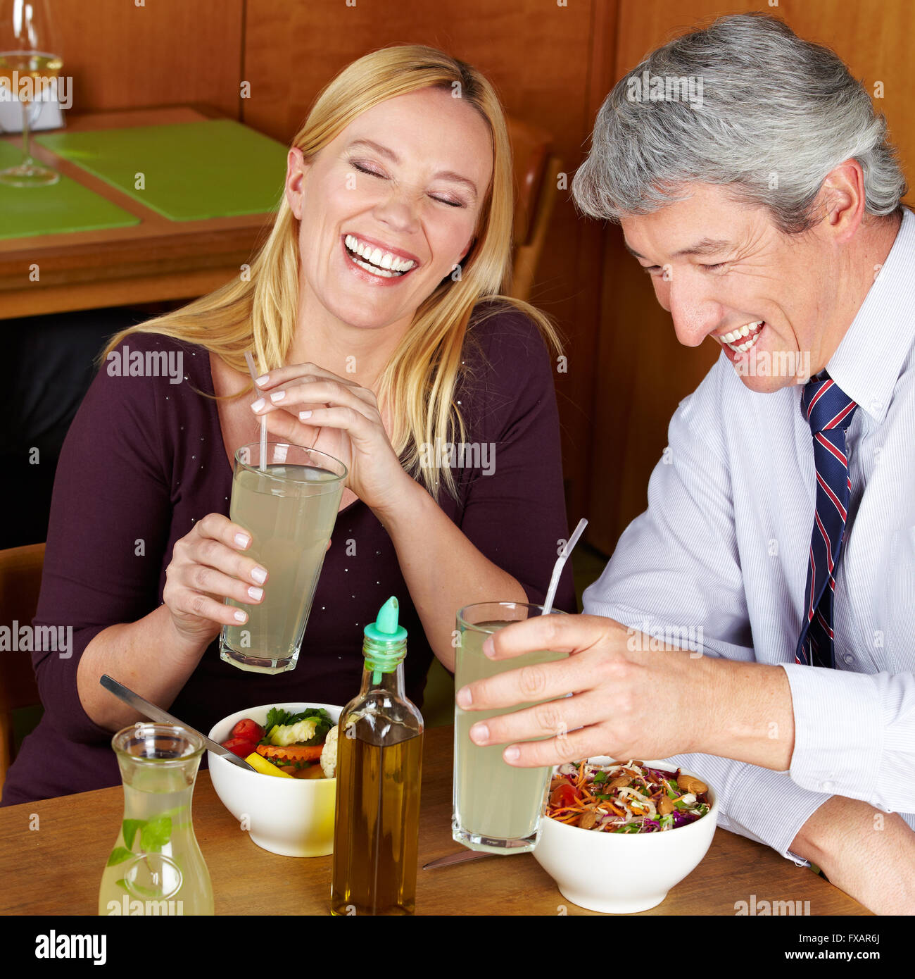Smiling happy elderly couple having dinner in a restaurant Stock Photo