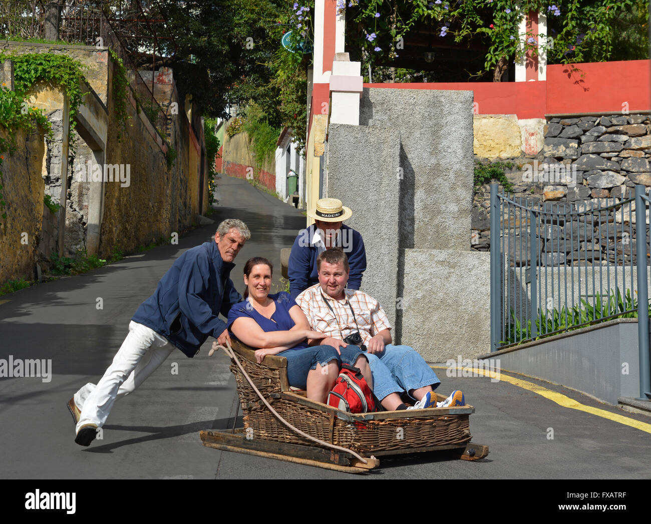 Tourists being guided downhill in wicker tobaggan or sled at Monte near