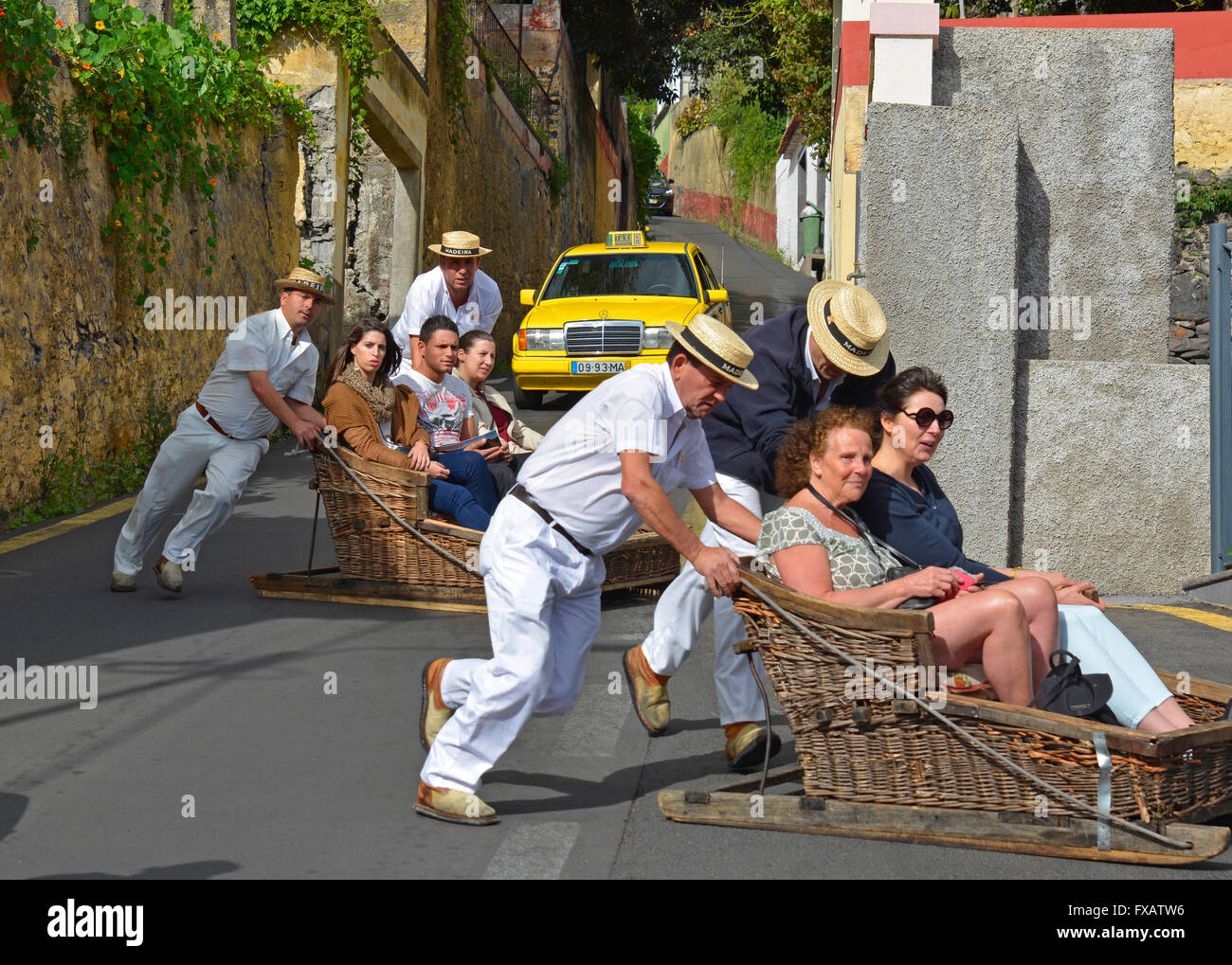 Tourists being guided downhill in wicker toboggans or sleds at Monte