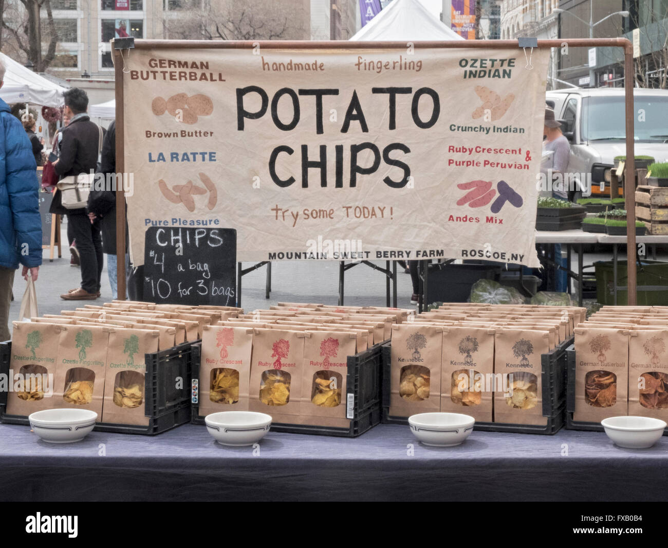 Various flavor potato chips for sale by an upstate New York farmer at the Union Square Green Market in New York City. Stock Photo