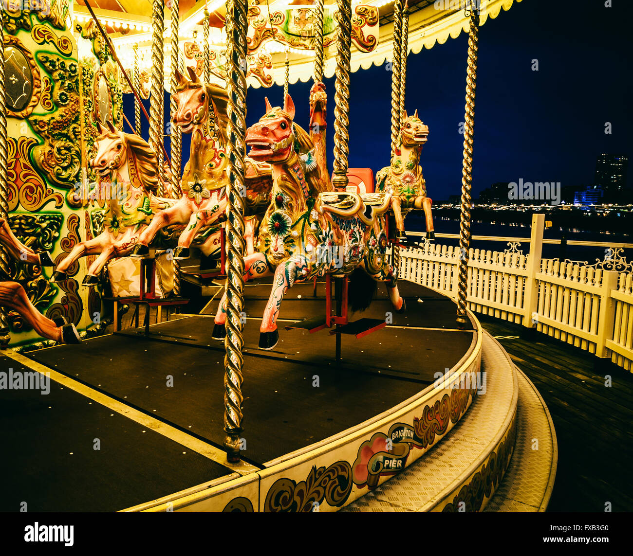 Merry-go-round on Brighton Pier at night, UK Stock Photo
