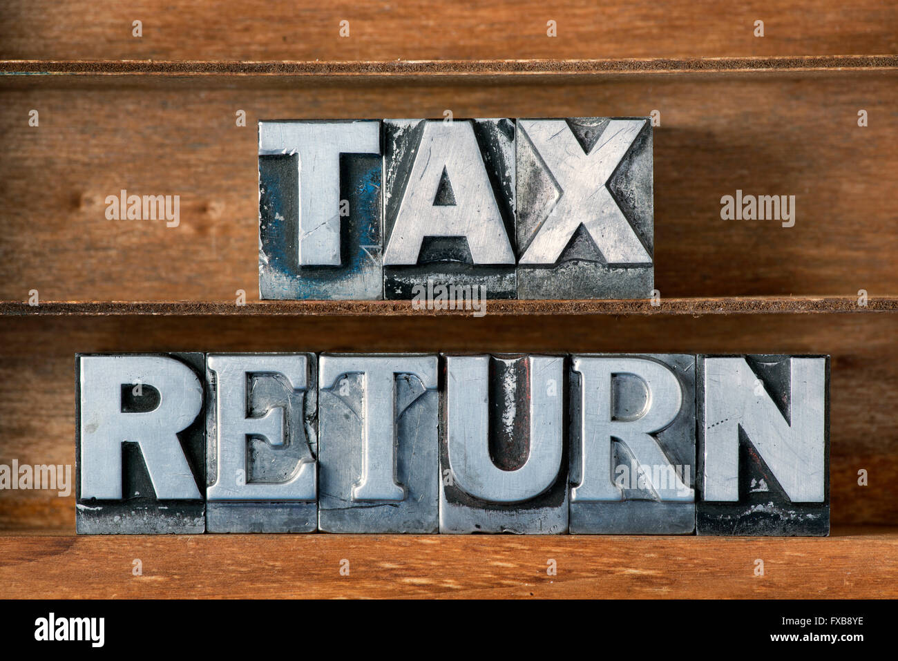 tax return phrase made from metallic letterpress type on wooden tray Stock Photo