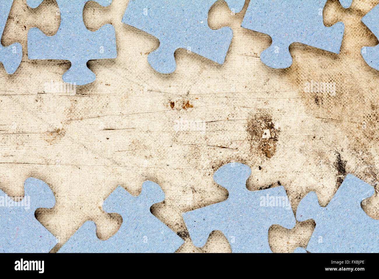 Blue puzzle frame with old canvas background for copy-space Stock Photo
