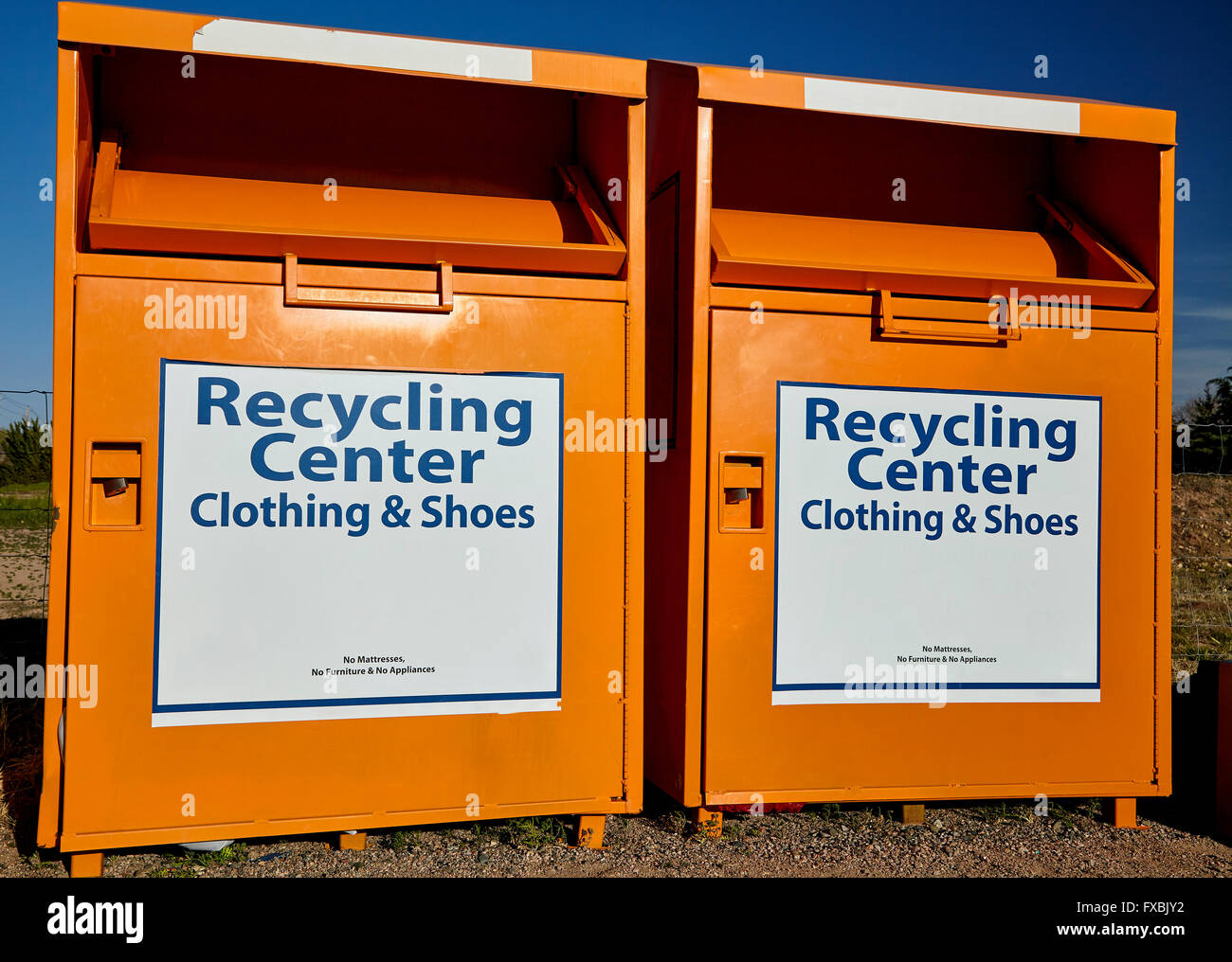 Recycling center collection bins for clothing disposal industry and waste management Stock Photo
