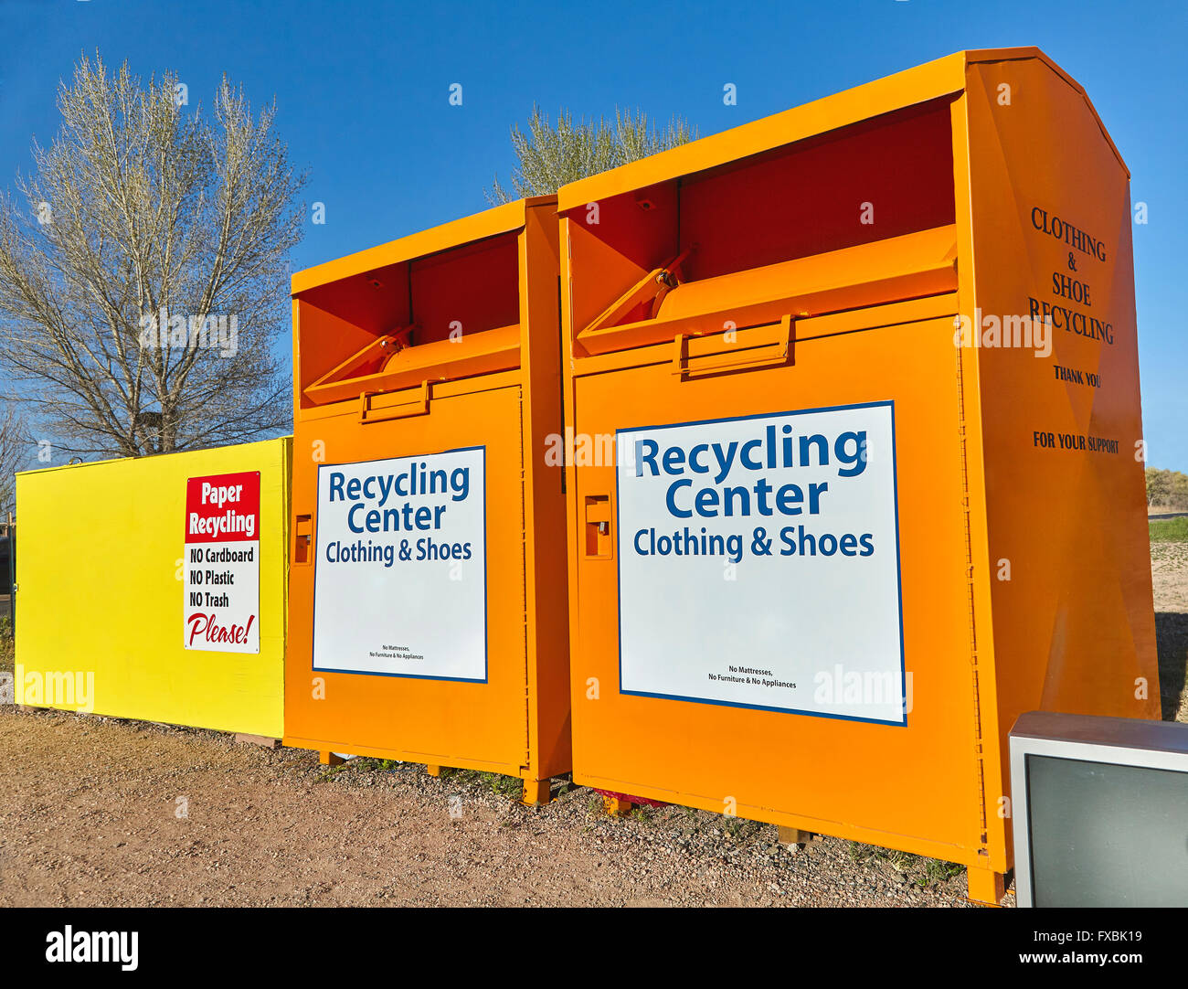Recycling center collection bins for paper clothing disposal waste management Stock Photo