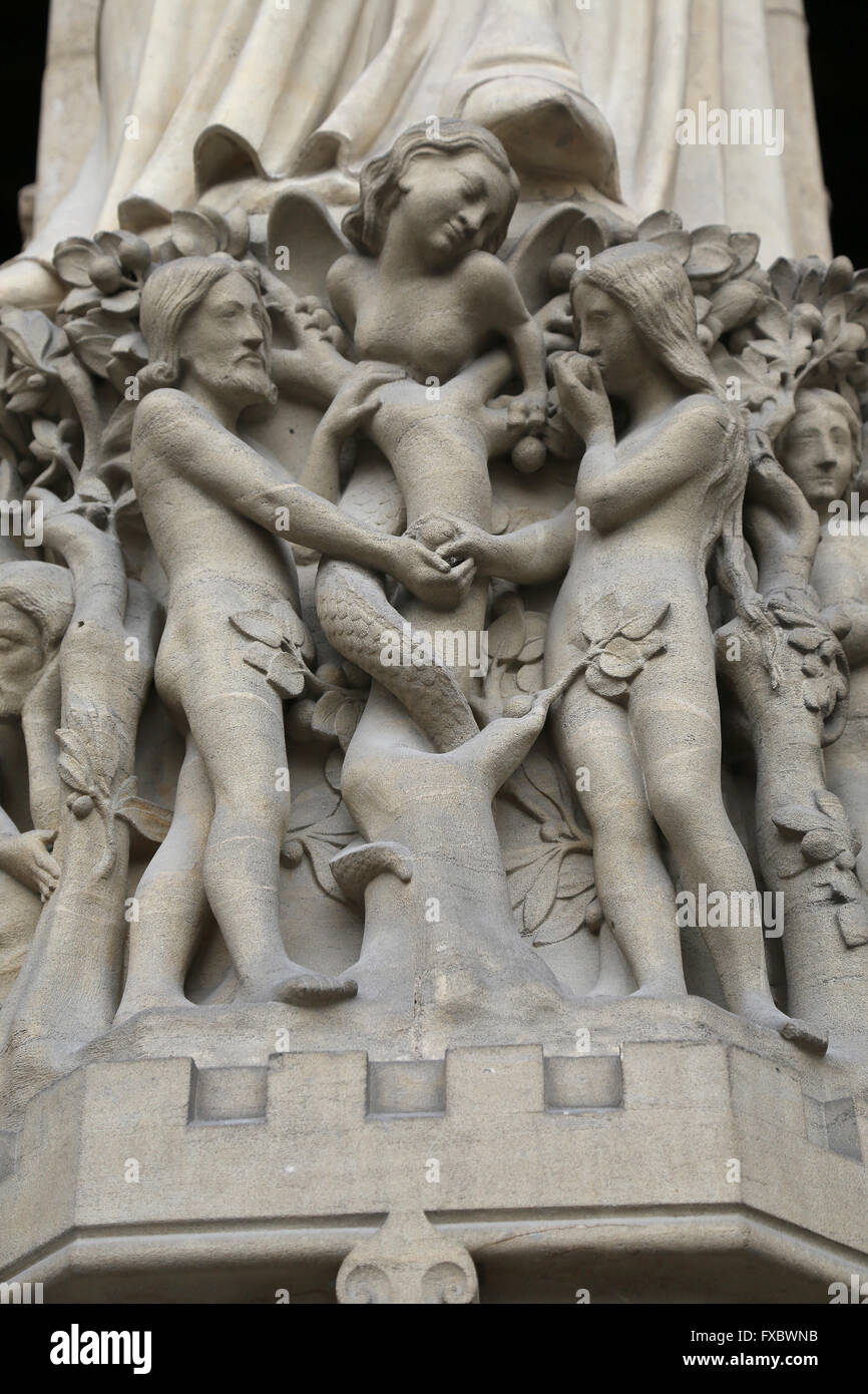 Adam Eve and  the Serpent. Notre Dame. Paris, France. West facade. Statues rebuilt by Viollet-Duc, 19th c. Stock Photo