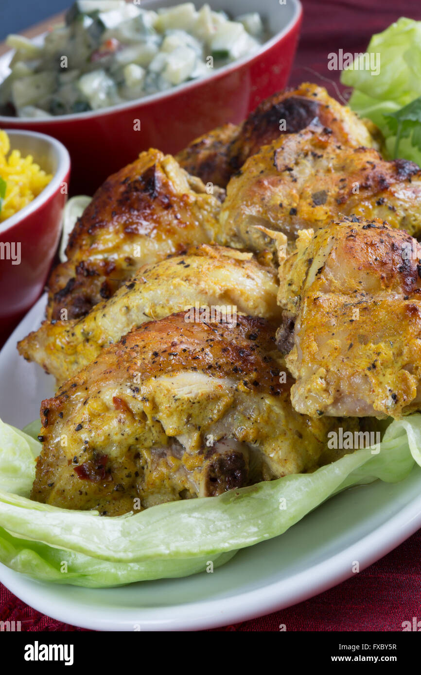 A homemade portion of Indian style Chicken Tandoori with Riata dip Stock Photo
