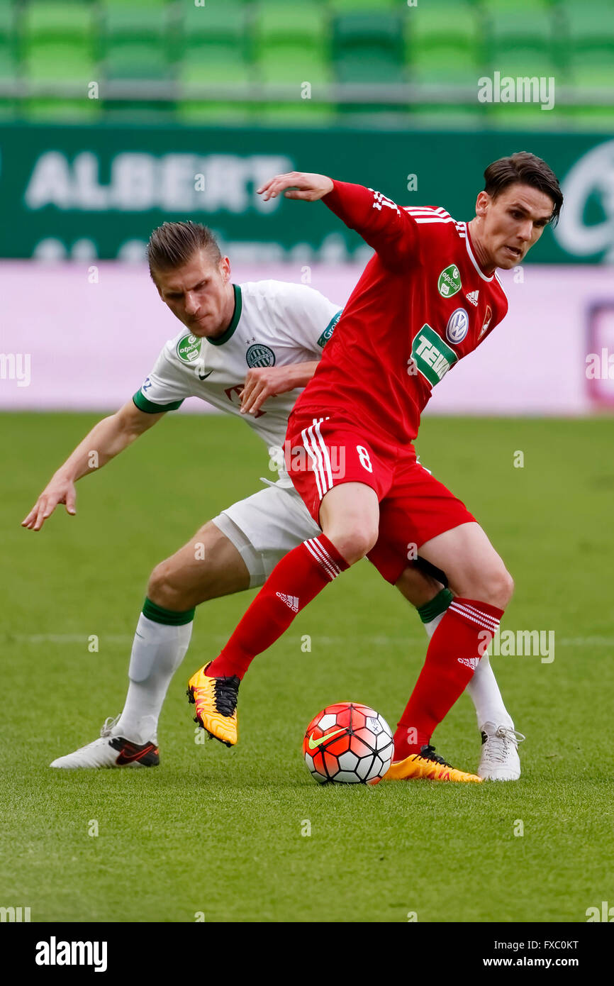 BUDAPEST, HUNGARY - APRIL 13, 2016: Gabor Gyomber Of Ferencvaros (l) Shots  On Target Next To Norbert Meszaros Of DVSC During Ferencvaros - DVSC  Hungarian Cup Semi-final Football Match At Groupama Arena.