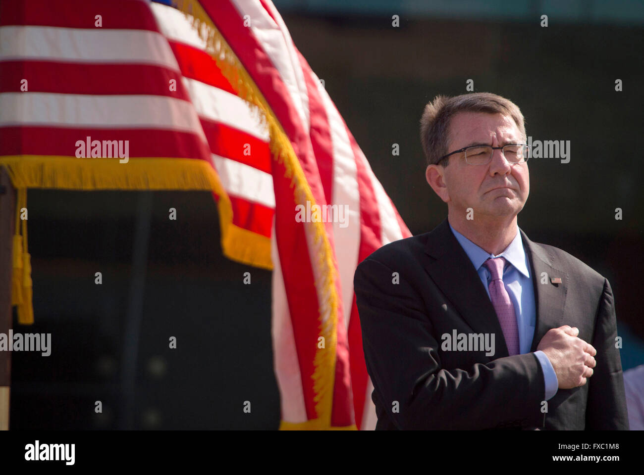New Delhi, India. 12th April, 2016. U.S Secretary of Defense Ash Carter stands in honor during a repatriation ceremony of U.S service members returned by the Indian government April 13, 2016 in New Dehli, India. The remains are believed to be from a 1940's Army Air Force aircrew crash that occurred in India. Credit:  Planetpix/Alamy Live News Stock Photo