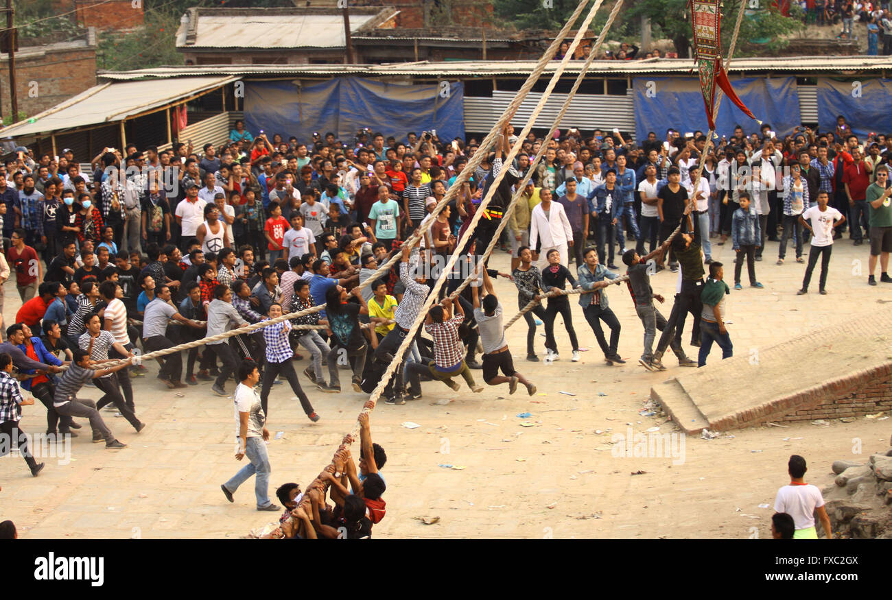 Bhaktapur, Nepal. 13th Apr, 2016. Nepalese devotees hang on the rope to