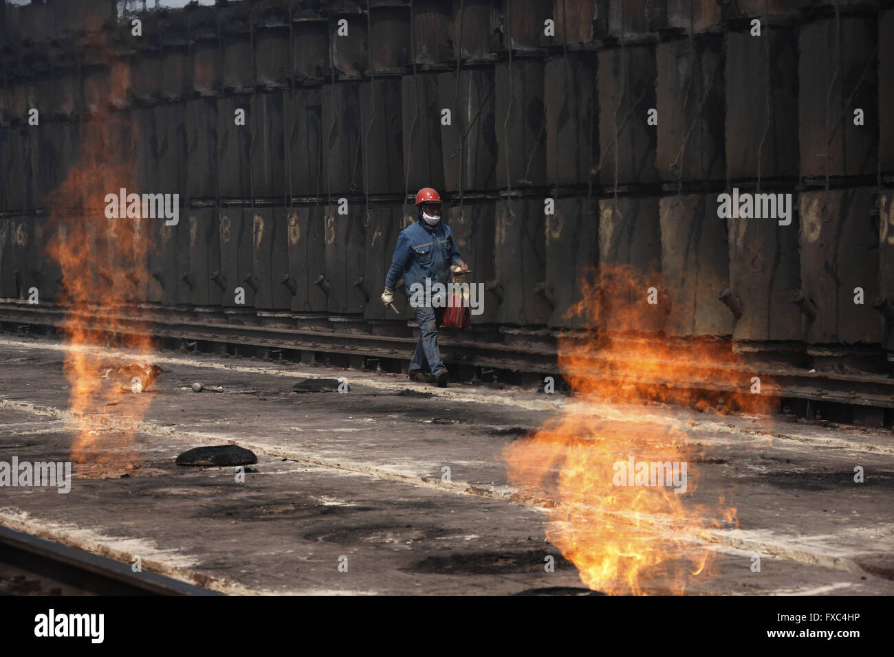 Huaibei, Huaibei, CHN. 13th Apr, 2016. Huaibei, CHINA - April 13 2016: (EDITORIAL USE ONLY. CHINA OUT) Coke oven workers step on the 1000-degrees-Celrius coke oven. It is totalling a flaming mountain here. They take coal out, load coal, push coke, block, sweep and dust, furnace temperature, open and close the riser, and tamp briquettes, push coke on trucks, trains, stop the coke car. Coal industry depresses now and influences their payment. But they still work off steam. © SIPA Asia/ZUMA Wire/Alamy Live News Stock Photo