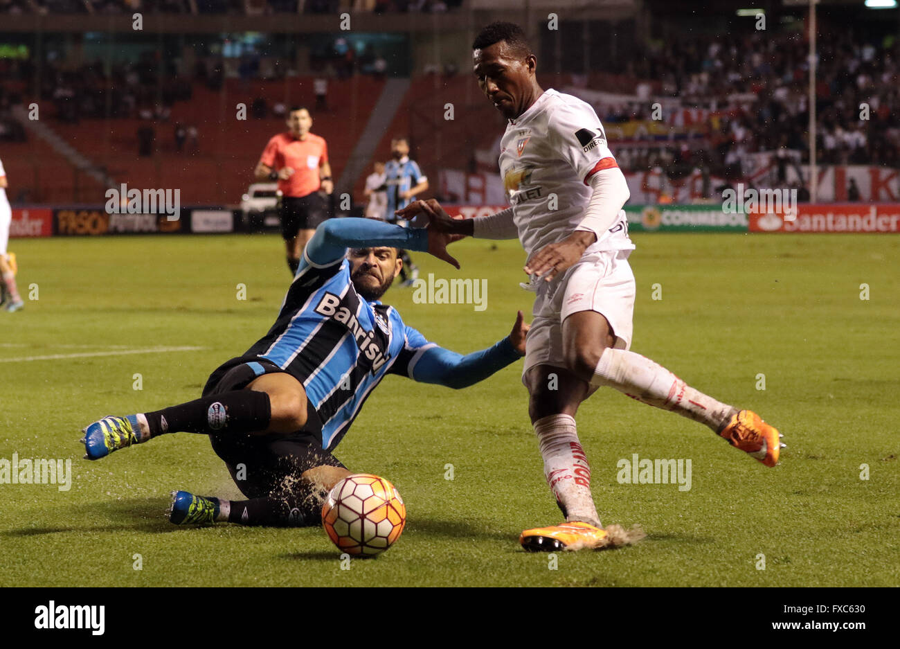 Quito, Ecuador. 13th Apr, 2016. Julio Ayovi (R) of Ecuador's Liga Sports University vies with Douglas of Brazil's Gremio during the match of the group stage of the Libertadores Cup at Casa Blanca, in Quito, Ecuador, on April 13, 2016. Brazil's Gremio won 3-2. © Santiago Armas/Xinhua/Alamy Live News Stock Photo