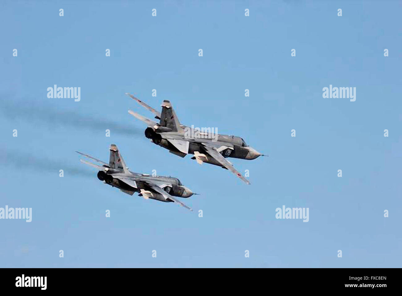 Two Russian Sukhoi Su-24 attack aircraft makes a very low altitude pass over the bow of the U.S Navy Arleigh Burke-class guided-missile destroyer USS Donald Cook during a patrol April 12, 2016 in the Baltic Sea. The aggressive flight maneuvers by the Russian aircraft simulated a strafing run. Stock Photo