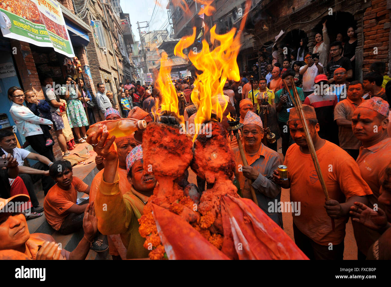 Kathmandu, Nepal. 14th Apr, 2016. A devotee add oil on torch frame