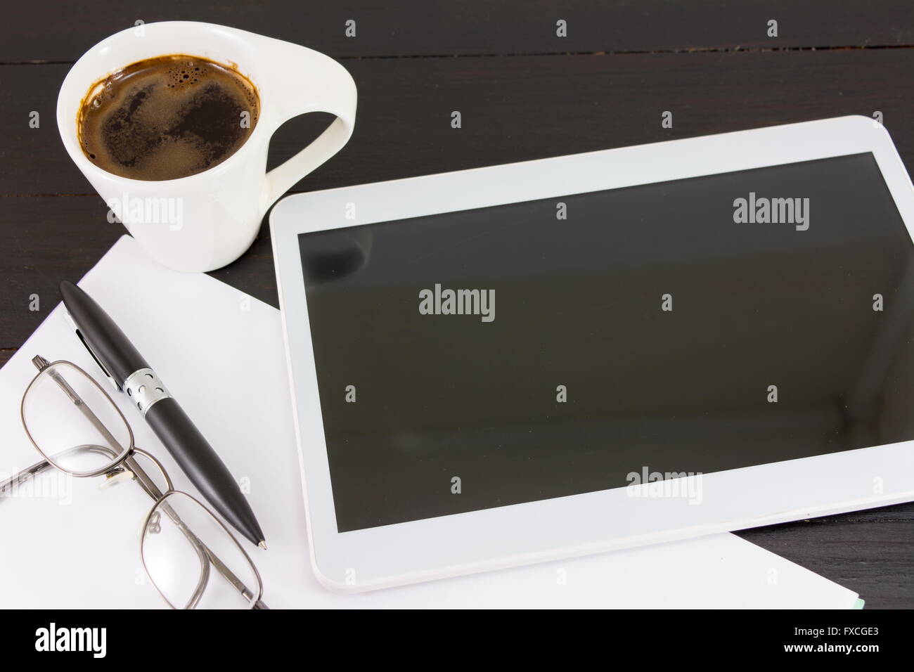 Cup of coffee for a good working day. Coffee and tech accessories on black table Stock Photo