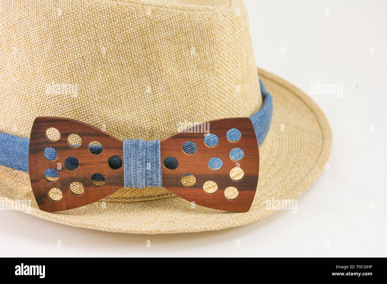 Wooden bow tie around a hat. Man accessories Stock Photo
