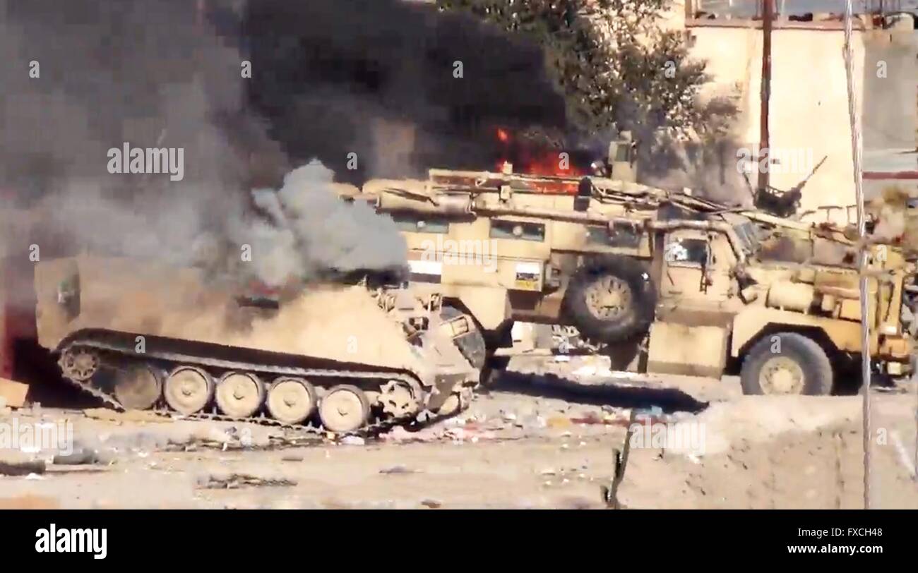 Iraqi armored vehicles burn after being destroyed in fighting against ISIS shown in an undated propaganda video capture released by the Islamic State of Iraq and the Levant during fighting in Anbar Province, Iraq. Stock Photo
