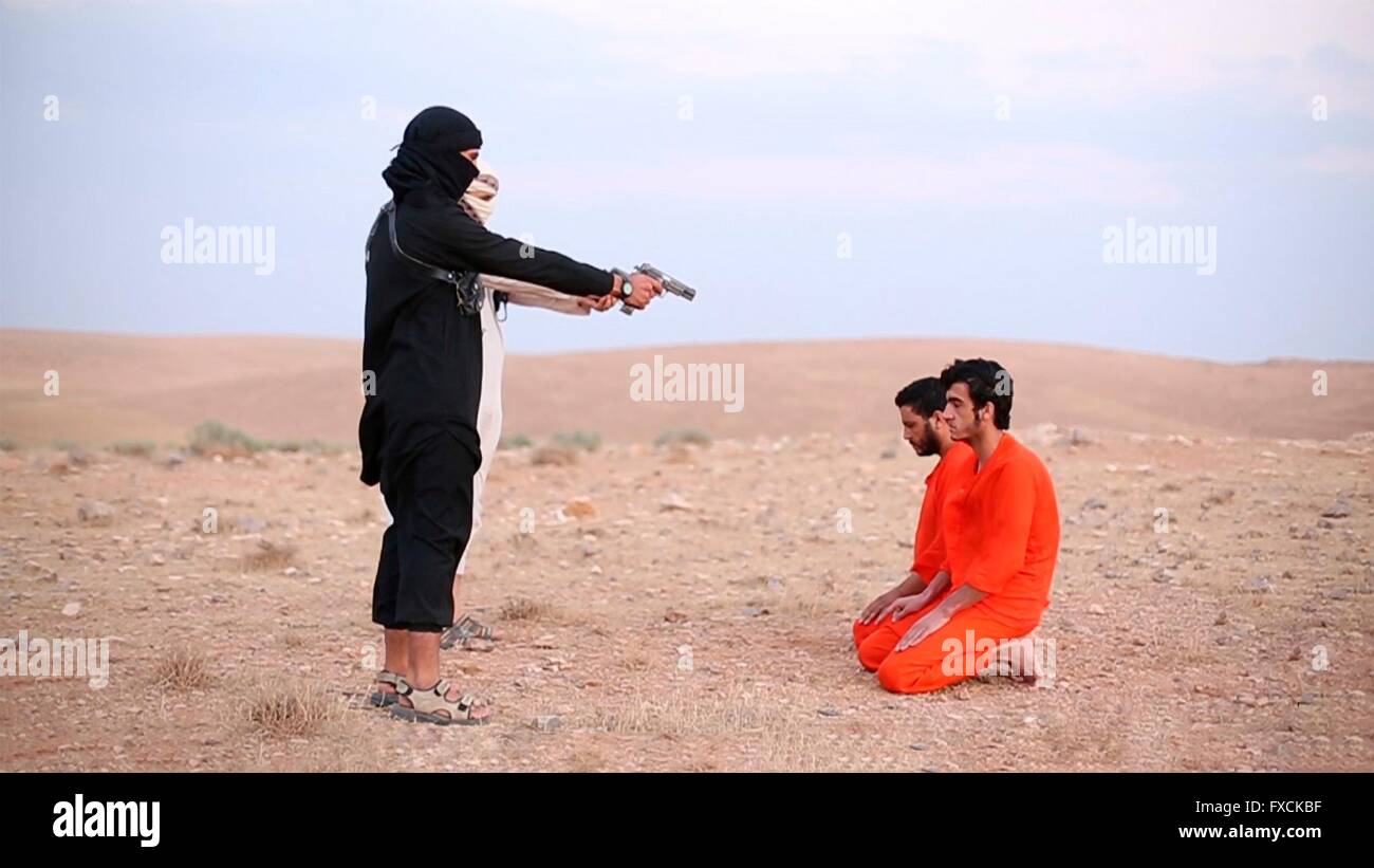 Islamic State fighter executes alleged spies in a propaganda video capture released by the Islamic State of Iraq and the Levant April 5, 2016 in Hama, Syria branch of ISIS. Stock Photo