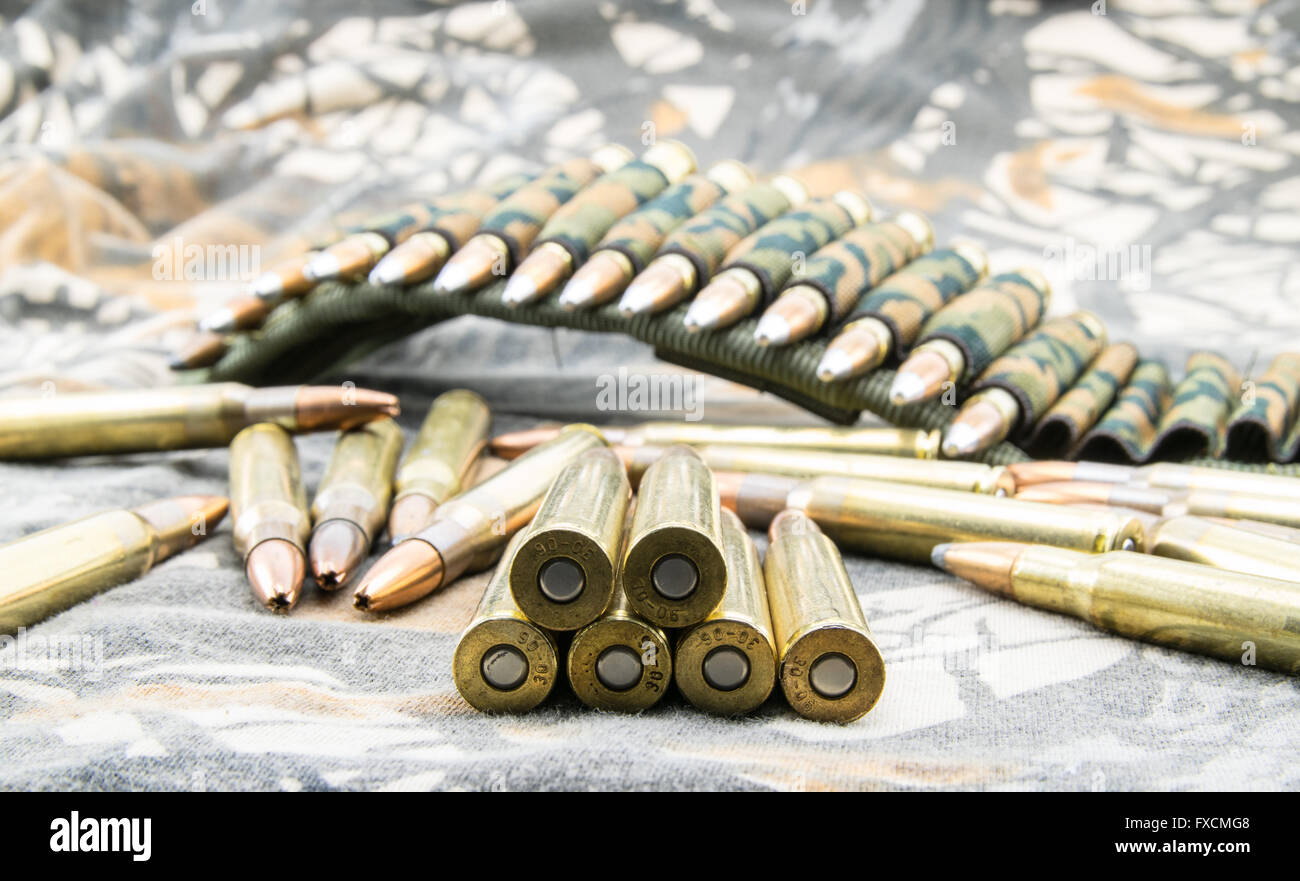 Hollow-point ammunitions for rifle  on camouflage background. Stock Photo