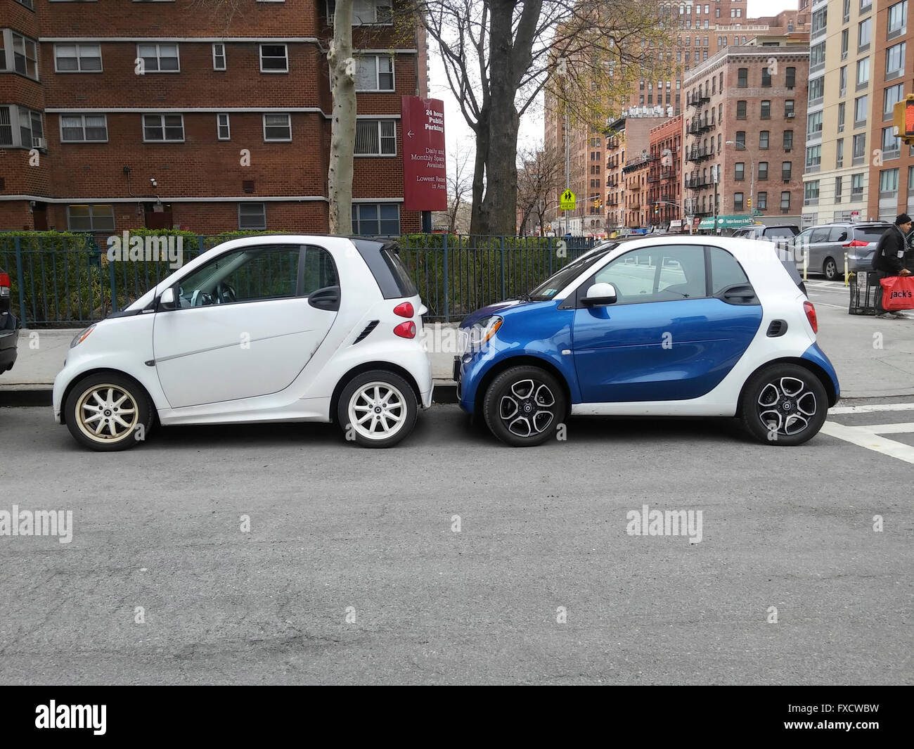 A pair of twoseat Smart cars, manufactured by Daimler, squeezed into a