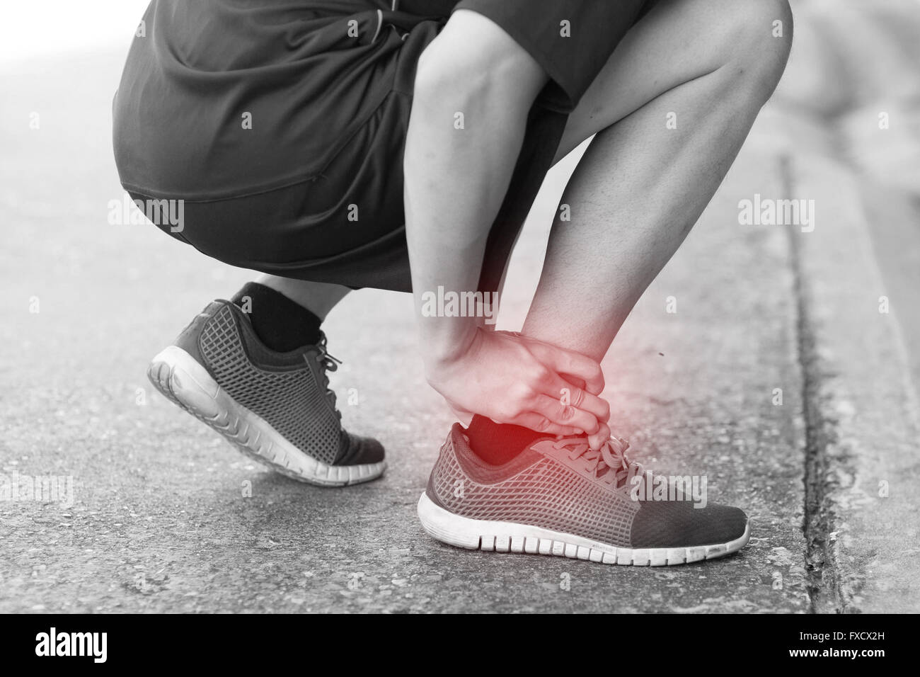Runner touching painful twisted or broken ankle. Athlete runner