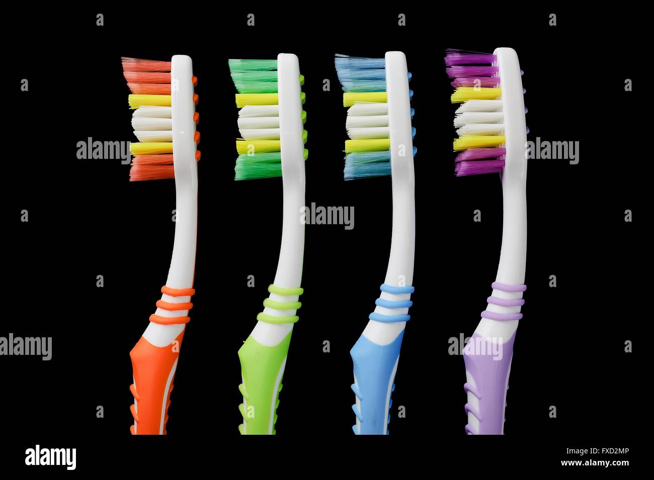 Four toothbrushes isolated on black Stock Photo