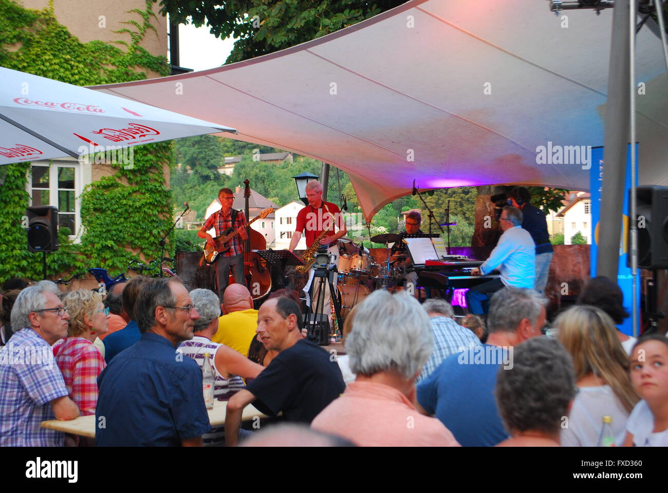 People watch an openair concert in the summer Stock Photo