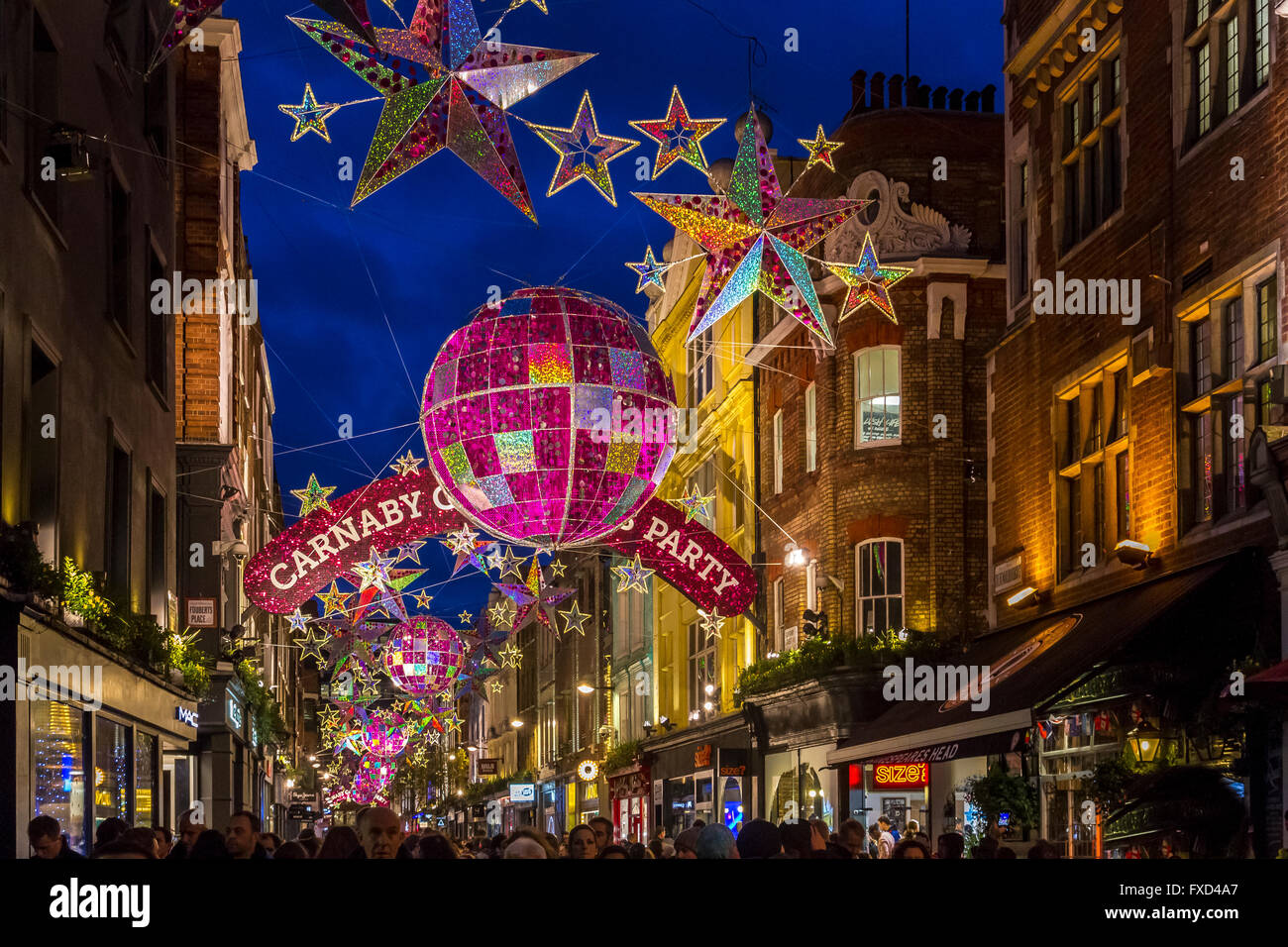 Carnaby Street at Christmas, with street decorations and lights suspended  above the Soho Street in London's West End, London, UK Stock Photo - Alamy