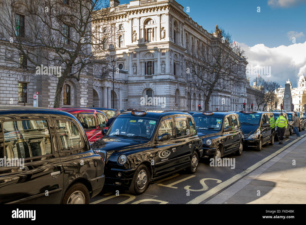 A London Taxi Drivers Association protest against Uber in London. Black London Taxis blockade Whitehall in a demonstration against Uber, London ,UK Stock Photo