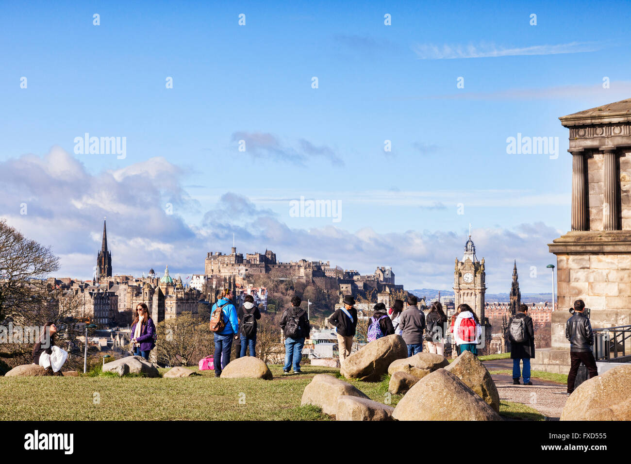 A group of young tourists look out on the Edinburgh skyline from Calton Hill, Scotland, UK Stock Photo
