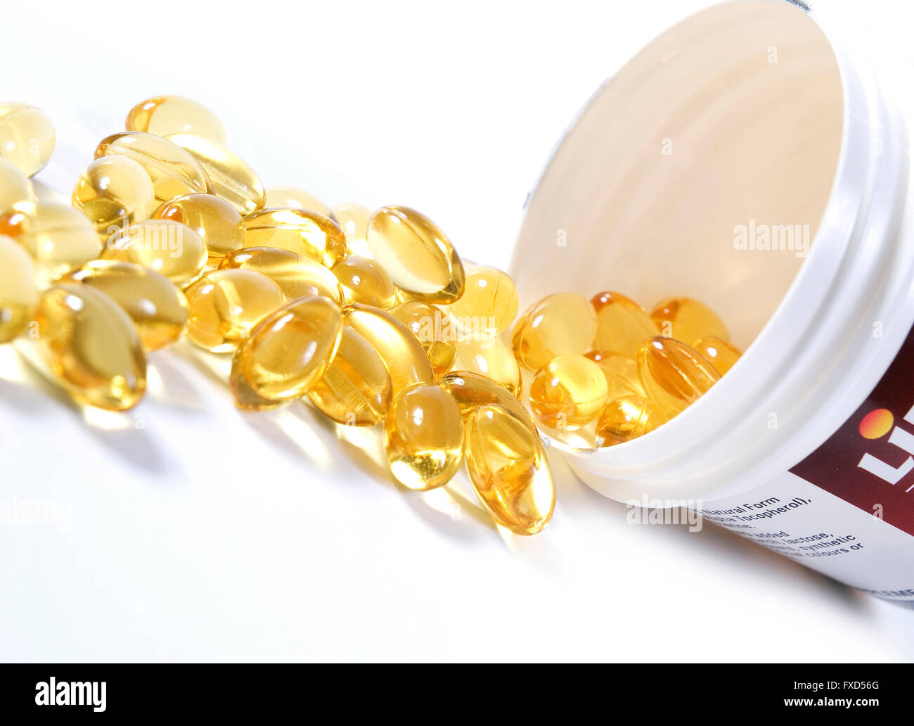 Vitamin E capsules spill out of container Stock Photo Alamy