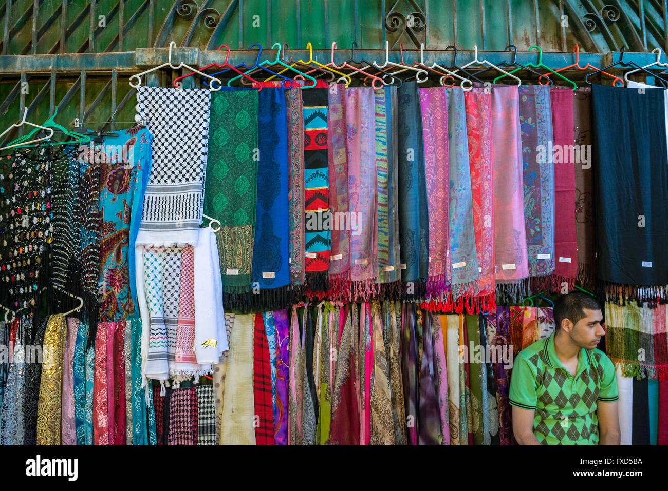 Man selling scarfs at Arab market that sprawls across Christian and Moslem Quarters on the Old City of Jerusalem, Israel Stock Photo