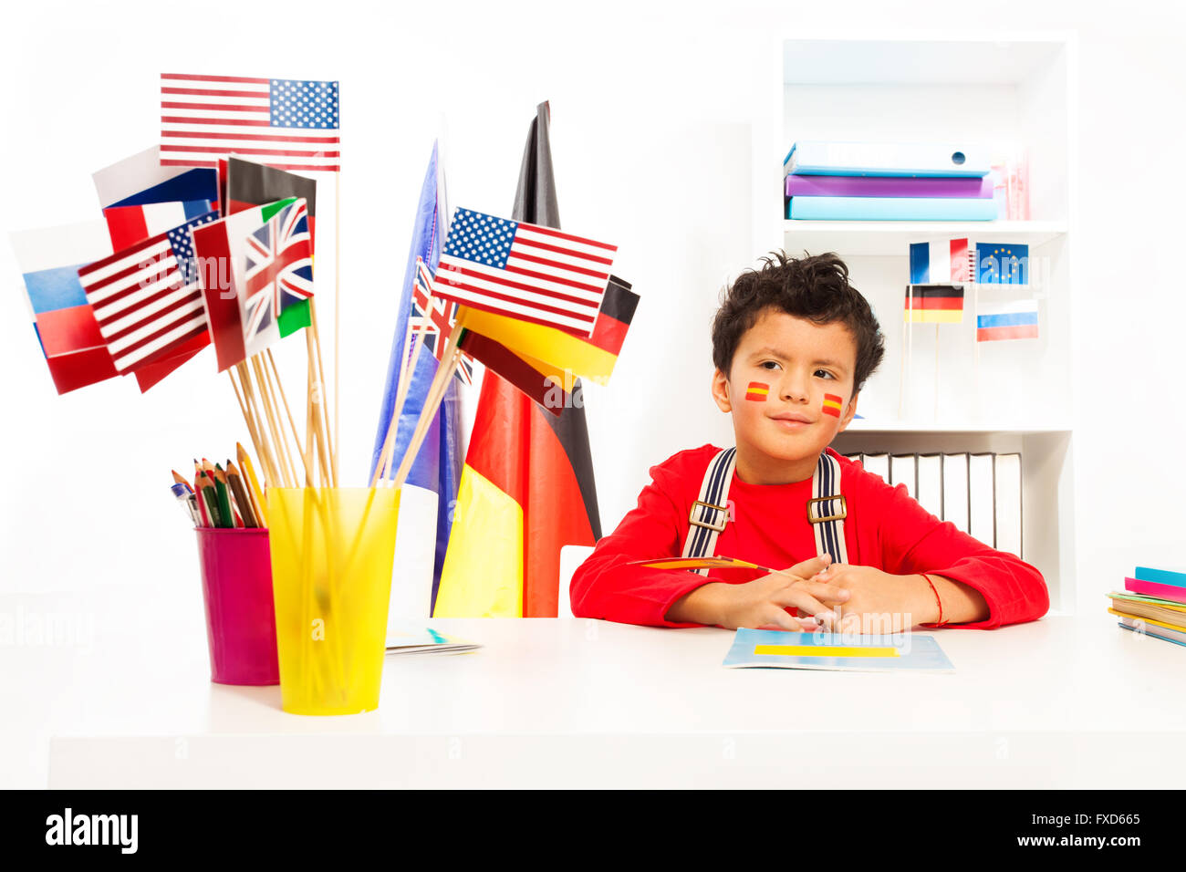 Spanish boy learning geography sitting at the desk Stock Photo