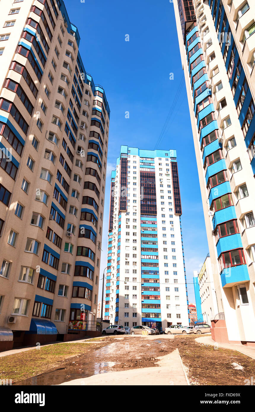 New tall apartment buildings against blue sky background Stock Photo ...