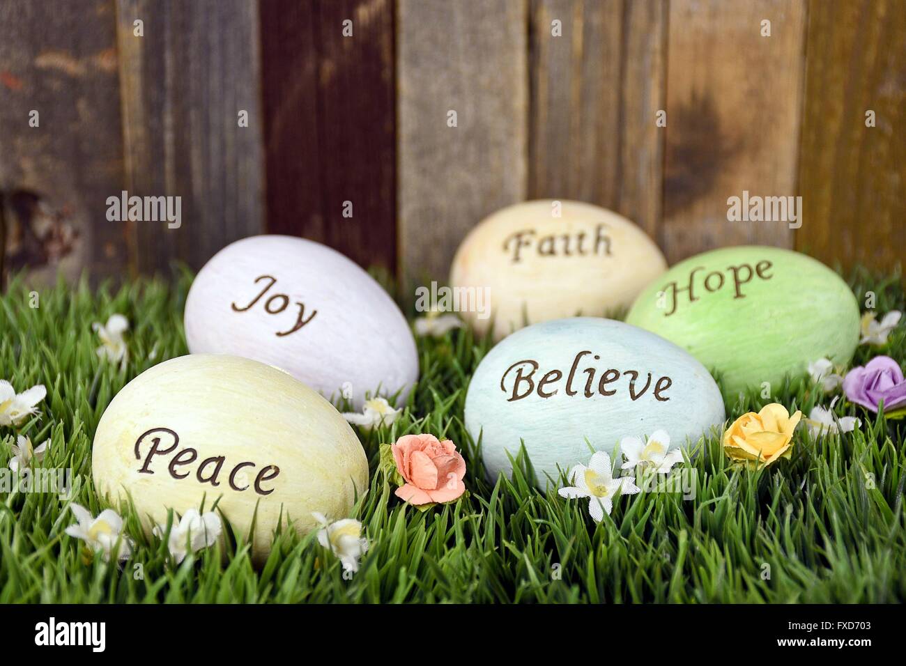 Inspirational words on pastel Easter eggs in grass. Stock Photo