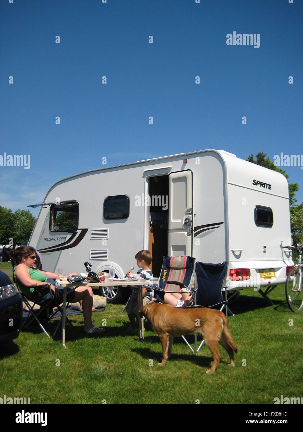 Family caravanning at the Camping & Caravanning Club's Scarborough site, North Yorkshire Stock Photo