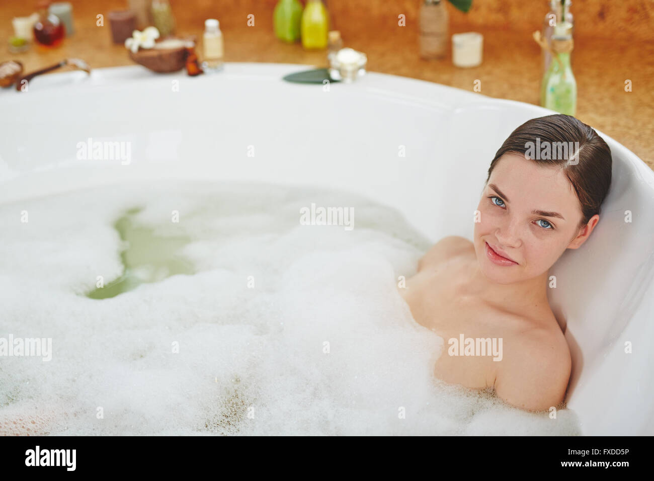 Young woman lying in bathtub hi-res stock photography and images - Alamy