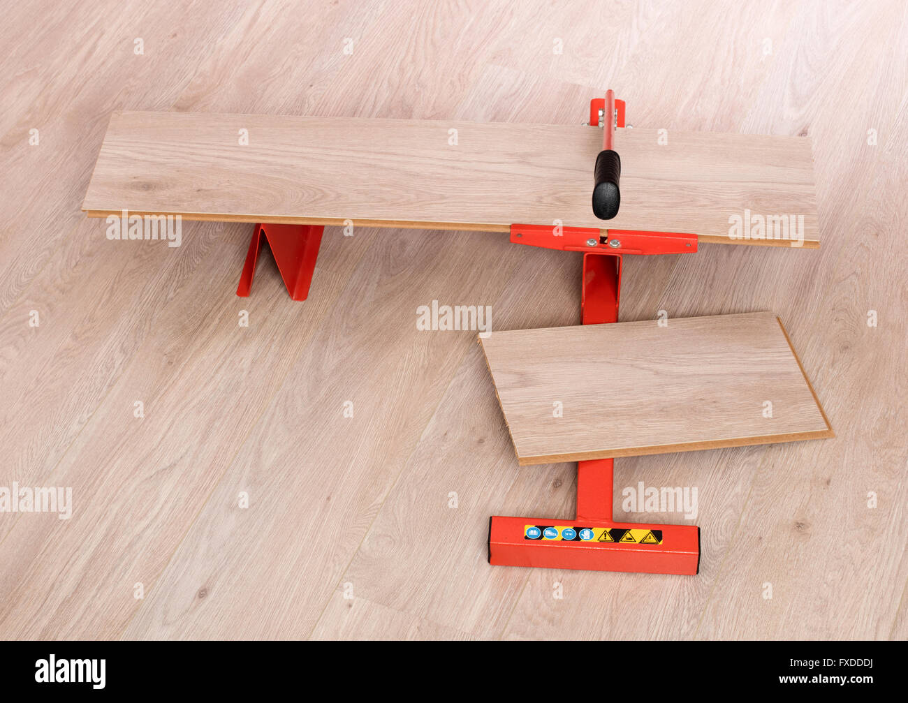 Red Tool For Cutting Laminate On A Laminate Floor Stock