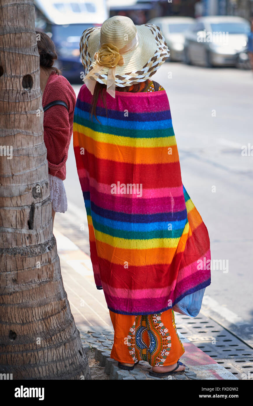 Chinese tourists and colourful beach towel at Pattaya Thailand