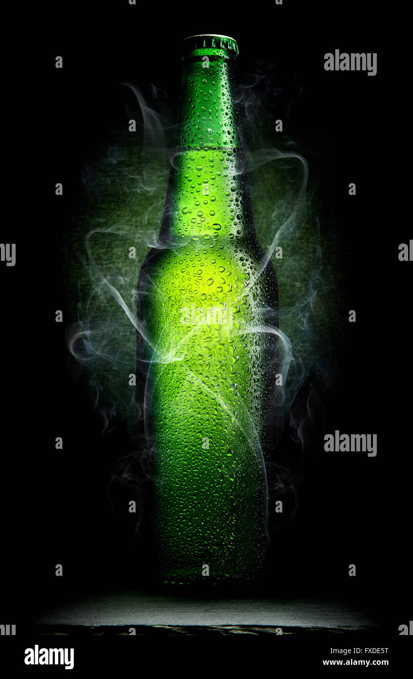 Close-up shot of green alcohol bottle with cigarette lighter and cigarettes  Stock Photo - Alamy