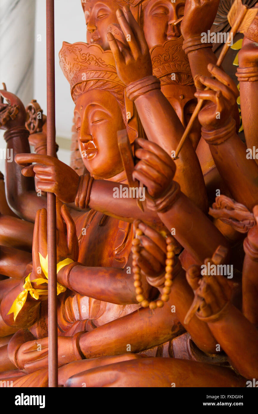 Buddha statue with mupltiple arms, wooden Stock Photo