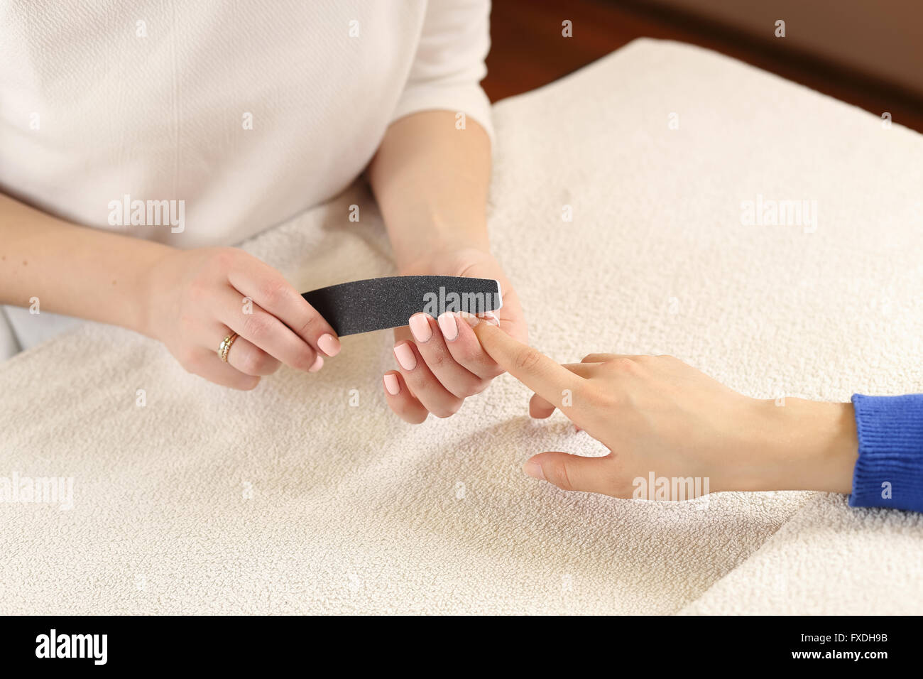Filing nails process in spa salon Stock Photo
