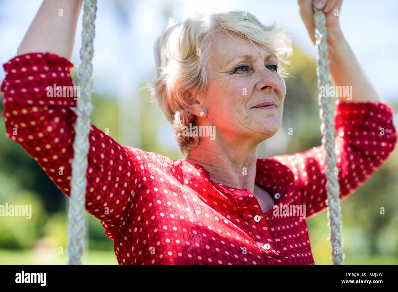Senior woman on swing hi-res stock photography and images - Alamy