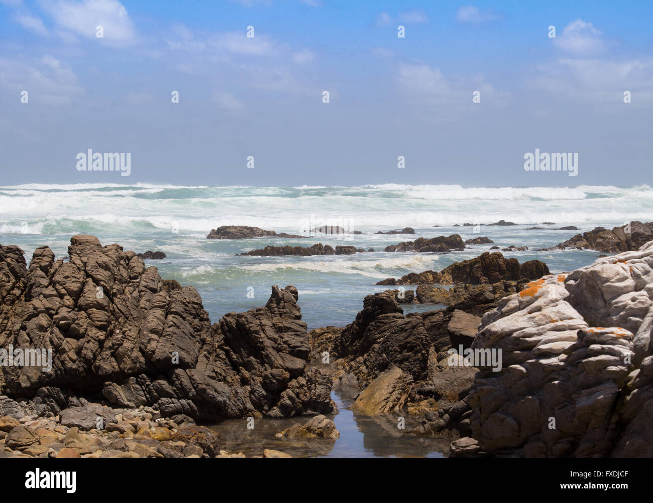 Ocean waves against the rocks at Cape Agulhas South Africa Stock Photo
