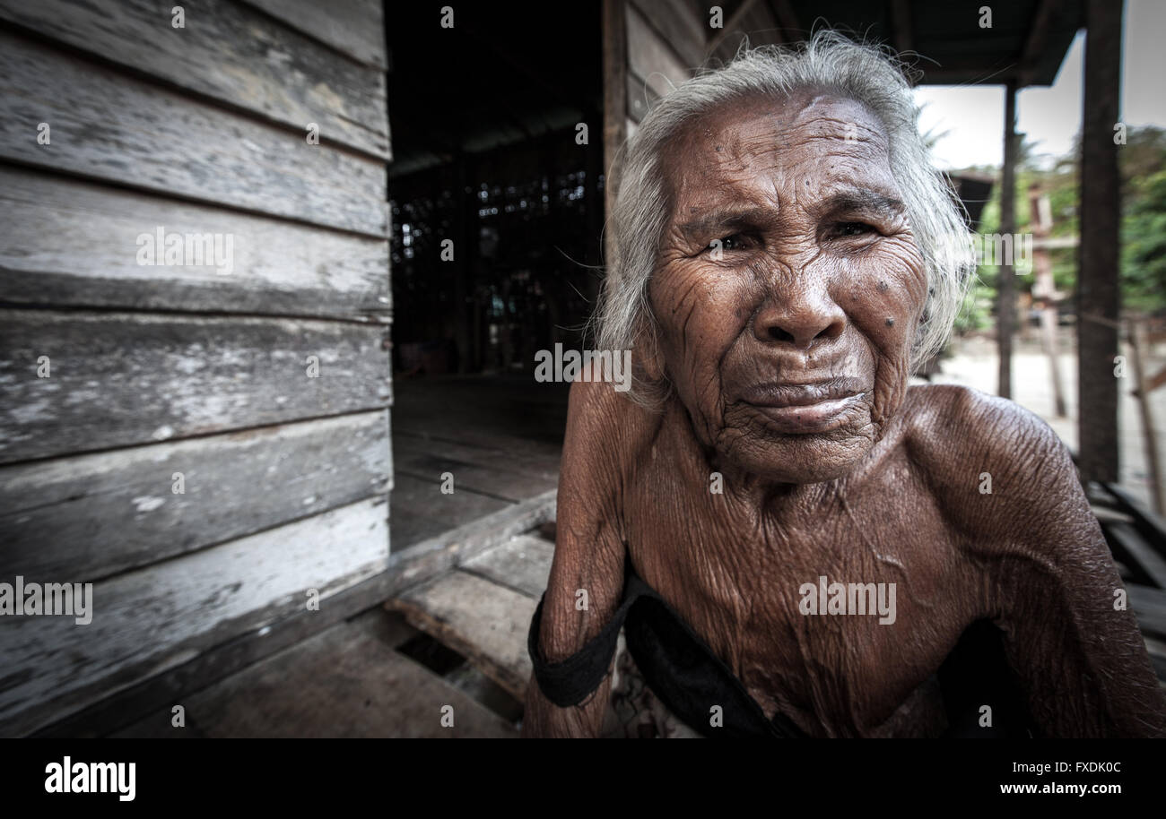 Burma, Myanmar, an old woman with white hair and tanned wrinkled skin. Stock Photo