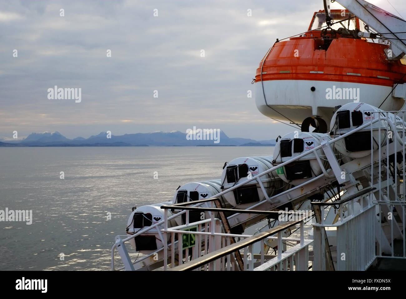 Lifeboat on davits, on the 'MV Isle of Lewis' ferry boat off the northwest coast of Scotland, UK. Stock Photo
