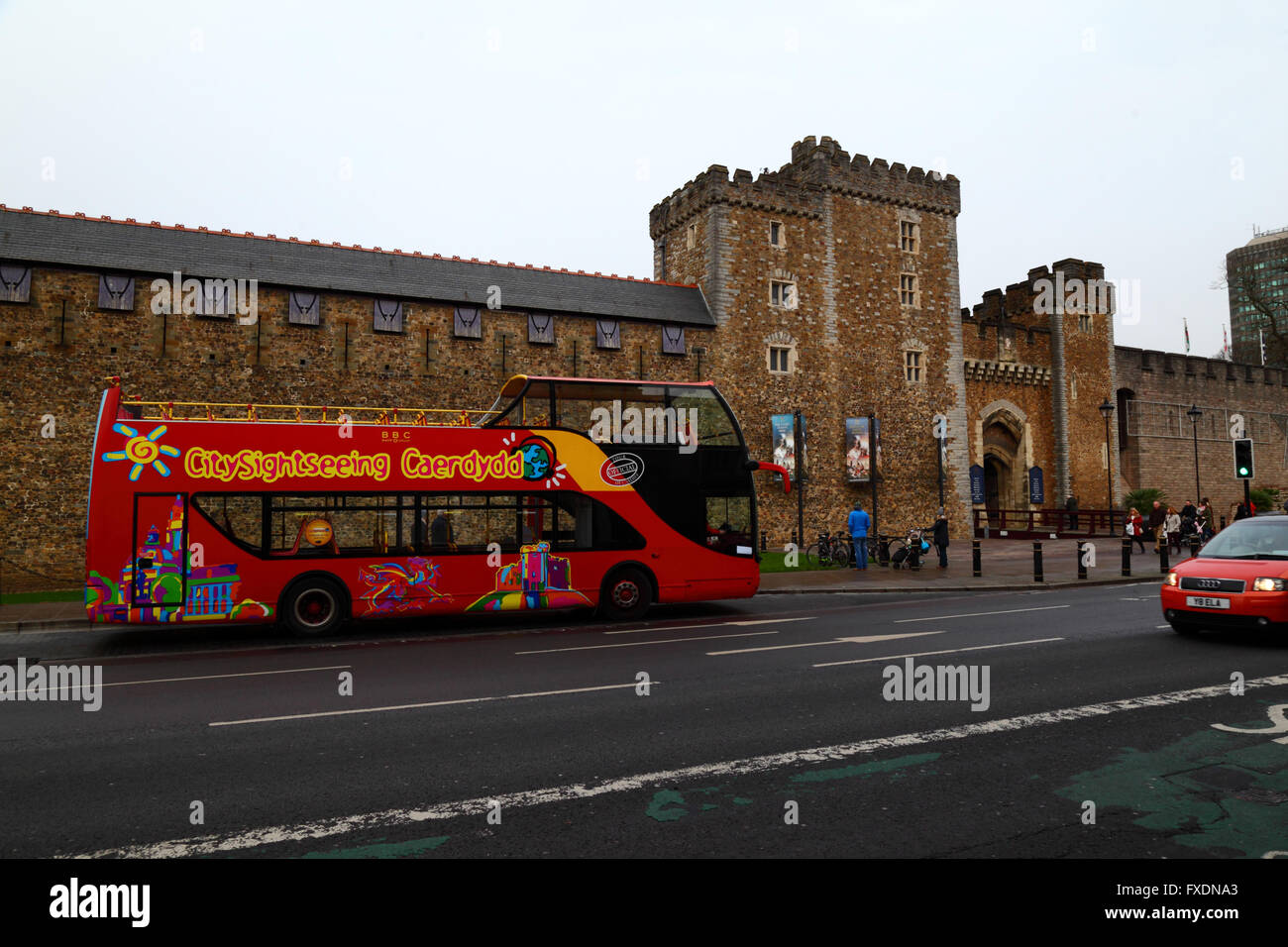 Open topped double decker tour bus in front of the Black Tower, South Gate and barbican, the main entrance to Cardiff Castle, South Glamorgan, Wales Stock Photo