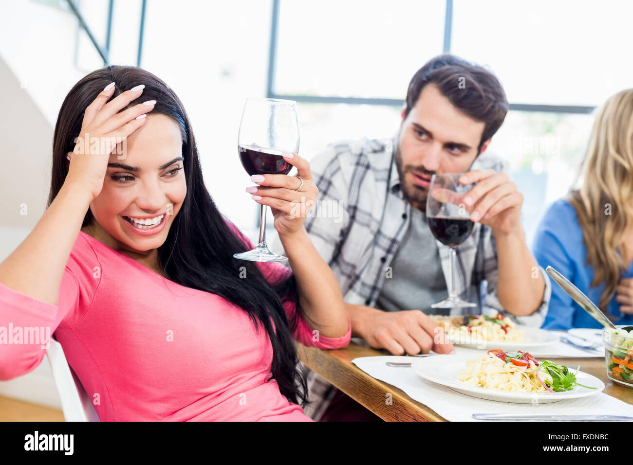Man looking drunk woman with wine glass Stock Photo