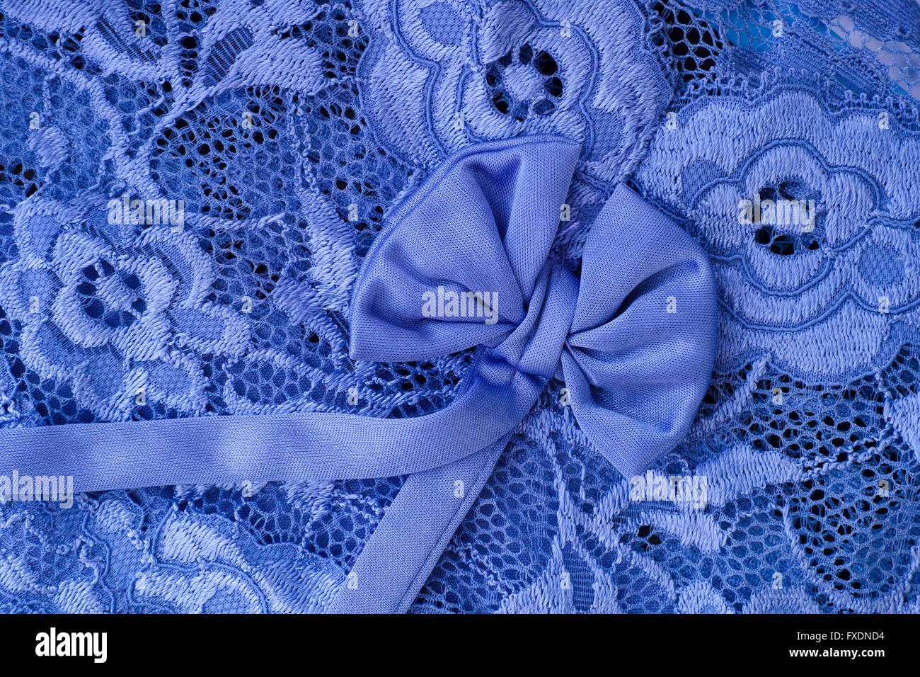 Blue lace with bow background. Close up. Stock Photo
